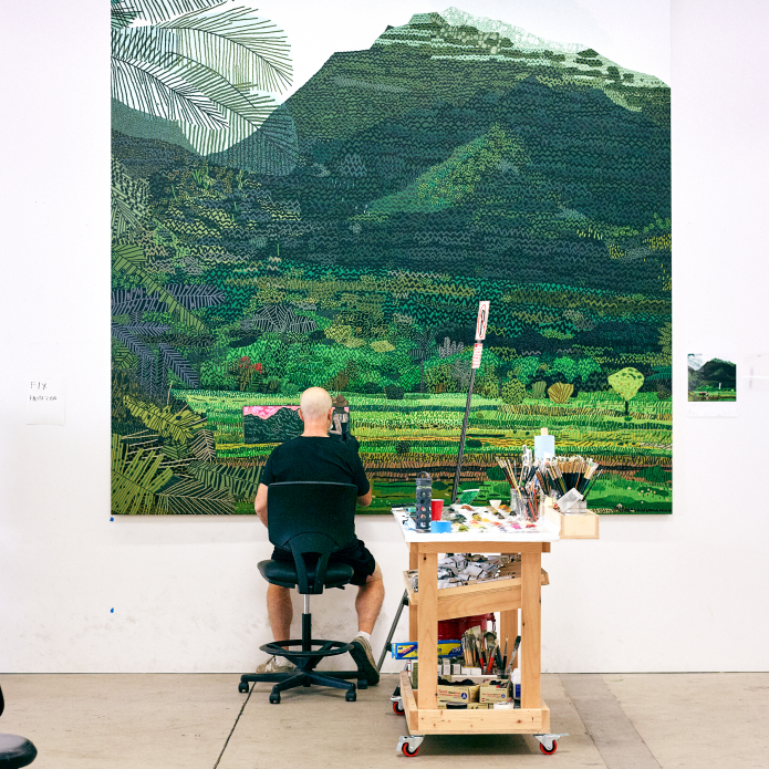 man painting from photograph