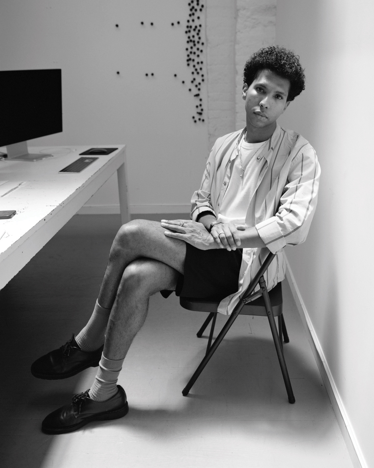 A man sitting by a desk.
